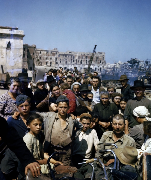 Foto Nara: sfollati italiani attendono in un punto di raccolta ad Anzio l’imbarco sulle navi che li porteranno a Napoli, giugno 1944 Foto Nara: sfollati italiani attendono in un punto di raccolta ad Anzio l’imbarco sulle navi che li porteranno a Napoli, giugno 1944